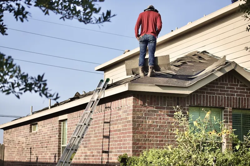 Professional roofer working on a residential roof in Amity Harbor